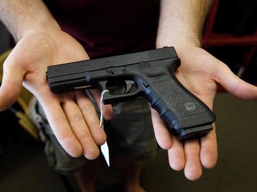 A Glock 22 pistol is displayed at the Rocky Mountain Guns and Ammo store in Parker, Colorado, July 24, 2012