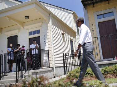 Local residents take pictures as U.S. President Barack Obama visit an area reconstructed after Hurricane Katrina during a presidential visit to New Orleans, Louisiana, August 27, 2015