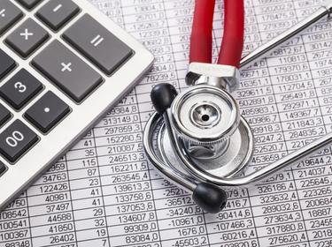 Calculator and stethoscope on a spreadsheet