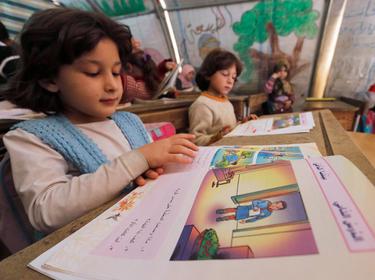 Girls attend a class at the Bab Al-Salam refugee camp in Azaz, near the Syrian-Turkish border, November 19, 2014