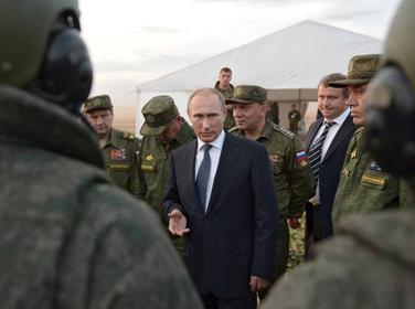 Russian President Vladimir Putin talks to servicemen during a training exercise at the Donguz testing range in Orenburg region, Russia, September 19, 2015