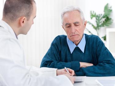 A senior man receives a consultation from his doctor