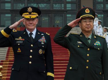 U.S. Army Gen. Martin E. Dempsey, the chairman of the Joint Chiefs of Staff, and Chinese army Gen. Fang Fenghui, China's chief of the general staff, salute during a ceremony in Beijing, April 22, 2013