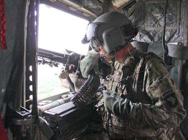 A U.S. Army crew chief scans his sector from a CH-47 Chinook helicopter in Afghanistan, May 8, 2015