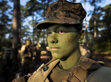 Pfc. Christina Fuentes Montenegro prepares to hike to her platoon's defensive position during patrol week of Infantry Training Battalion near Camp Geiger, N.C. in Oct. 2013