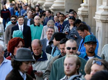 Job seekers wait to enter a job fair in downtown Denver, Colorado, March 13, 2014