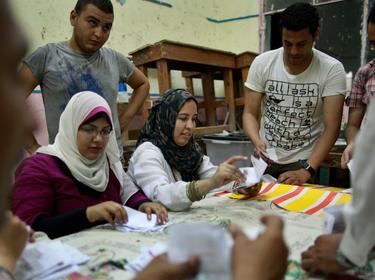 Officials count the ballots after the polls are closed in Cairo, Egypt, June 17, 2012