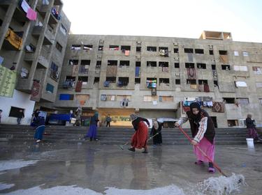 Women cleaning a compound housing Syrian refugees in Sidon, Lebanon, February 3, 2016