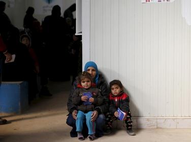 Syrian refugees wait to receive treatment at a health center in Mafraq, Jordan, January 30, 2016