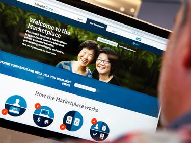 A man looks over the ACA signup page on HealthCare.gov, October 2, 2013