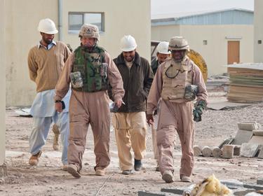 Contractor personnel inspect an Afghan national police facility