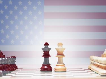 An American flag behind a chess board