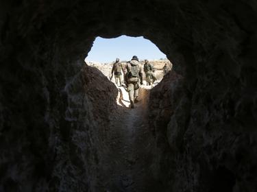 Rebel fighters walk out from a cave that was used by Islamic State militants, after they captured the area from them, on the outskirts of the northern town of al-Bab, Syria, February 2, 2017