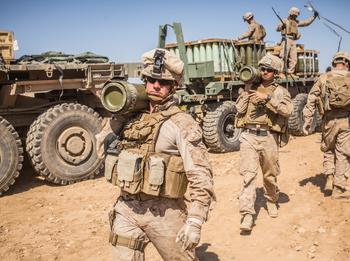 U.S. Marines carry 155mm rounds to an M777 Howitzer gun line to prepare for fire missions in northern Syria, March 21, 2017