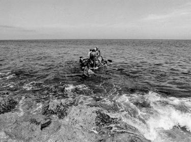 Would-be emigrants launch a makeshift boat into the Straits of Florida towards the U.S., on the last day of the 1994 Cuban Exodus in Havana, September 13, 1994