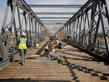 Workers repair a bridge in Mosul, Iraq, January 28, 2018