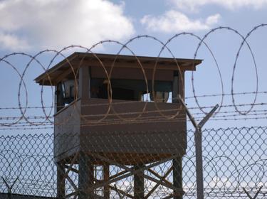 A soldier stands guard in a tower overlooking Camp Delta at Guantanamo Bay naval base, Cuba, December 31, 2009