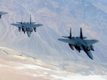 Four F-15E Strike Eagles fly in formation above the Nevada Test and Training Range June 21, 2011