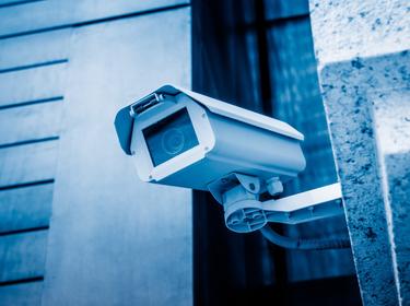 A surveillance camera on a building exterior