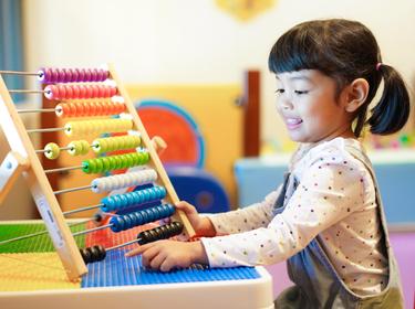 Cute Asian little kid girl playing with abacus at home. Smart child learning to count. learning, classroom, lesson concept, photo by Asada/AdobeStock
