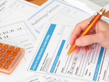 health insurance claim form, pen, calculator
