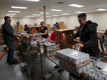 Employees and volunteers prepare relief boxes at the South Texas Food Bank in Laredo, Texas, March 20, 2020, photo by Veronica Cardenas/Reuters
