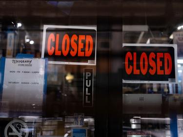 Temporary closed signage is seen at a store in Manhattan following the outbreak of COVID-19, in New York City, March 15, 2020, photo by Jeenah Moon/Reuters