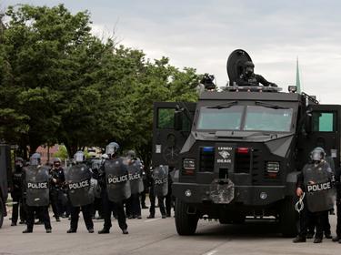 Detroit police line up next to an armored vehicle following a rally against the death in Minneapolis police custody of George Floyd, in Detroit, Michigan, June 1, 2020, photo by Rebecca Cook/Reuters