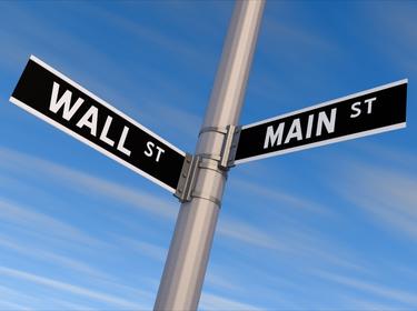 Street sign with Wall St. and Main St. signs, photo by BobHemphill/Getty Images