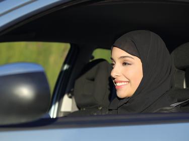 A Middle Eastern woman driving