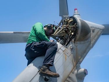 Aviation mechanic works on a Sea Hawk helicopter