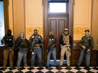 Members of a militia group who were charged in a plot to kidnap Michigan Governor Gretchen Whitmer, in the state capitol building, in Lansing, Michigan, April 30, 2020, photo by Seth Herald/Reuters