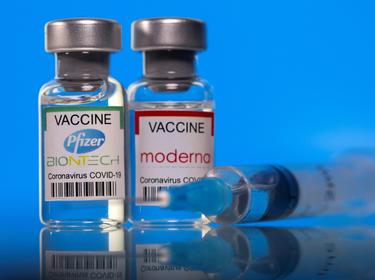 Vials with Pfizer-BioNTech and Moderna COVID-19 vaccine labels, March 19, 2021, photo by Dado Ruvic/Reuters