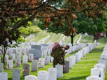 Soldiers assigned to the 3rd U.S. Infantry Regiment place American flags at headstones ahead of Memorial Day in Arlington National Cemetery, Arlington, Virginia, May 21, 2020, photo by Elizabeth Fraser/U.S. Army