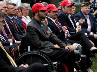 Veterans and other guests attend a signing ceremony for the VA Mission Act of 2018 in the Rose Garden of the White House, June 6, 2018, photo by Carlos Barria/Reuters