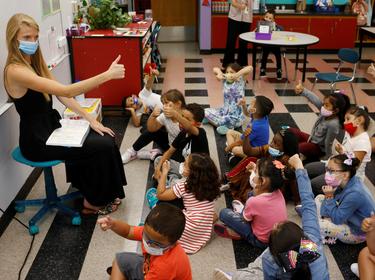 Teacher Emma Rossi works with her first grade students at the Sokolowski School in Chelsea, Massachusetts, September 15, 2021, photo by Brian Snyder/Reuters