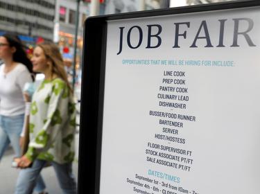 Signage for a job fair is seen on 5th Avenue after the release of the jobs report in New York City, September 3, 2021, photo by Andrew Kelly/Reuters