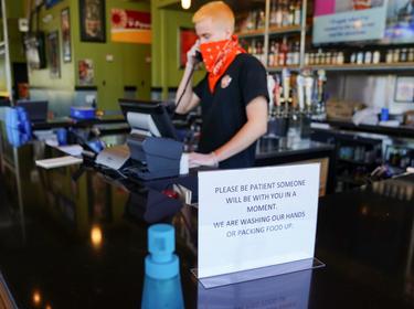 A worker at Bad Daddy's Burger Bar in Smyrna, Georgia, April 27, 2020, photo by Elijah Nouvelage/Reuters