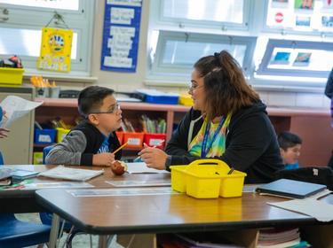 A teacher and student talking in a classroom, photo courtesy of Cowell Elementary School