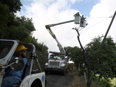 Puerto Rico Electric Power Authority workers repair part of the electrical grid after Hurricane Maria in Utuado, Puerto Rico, May 17, 2018, photo by Alvin Baez/Reuters