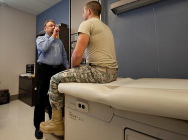 Dr. Gregory Johnson does a neurologic exam on U.S. Army Spc. Andrew Karamatic at Tripler Army Medical Center in Honolulu, Hawaii, March 20, 2014, photo by Staff Sgt. Christopher Hubenthal/U.S. Air Force
