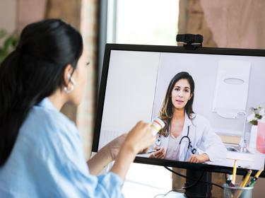 A woman talking to a doctor online, photo by SDI Productions/Getty Images