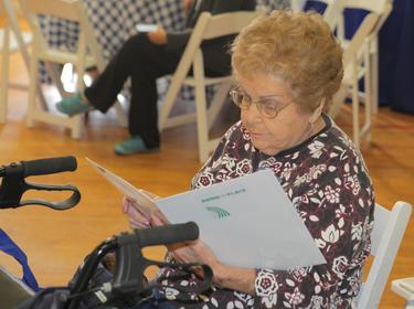 An attendee at a community meeting reads materials about aging in place in West Hollywood, California, May 9, 2015