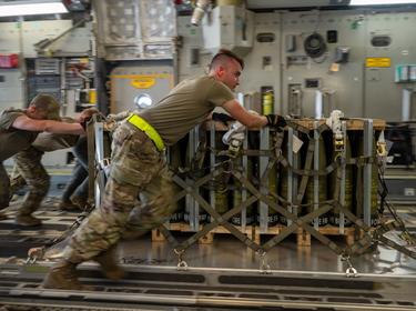 Airmen load ammunition onto a C-17 Globemaster III bound for Ukraine during a security assistance mission at Dover Air Force Base, Delaware, August 9, 2022, photo by Airman 1st Class Cydney Lee/U.S. Air Force