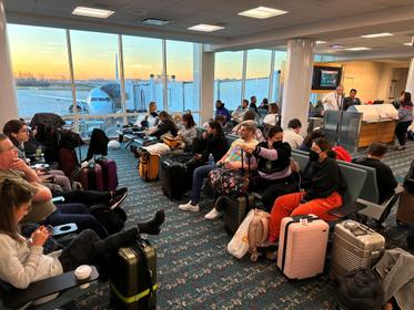 Stranded passengers wait at Orlando International Airport as flights were grounded after the FAA system outage, in Orlando, Florida, January 11, 2023, photo by Lou Mongello via Reuters