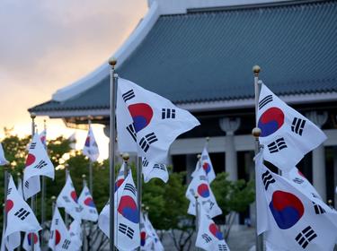 Korean national flags fluttering in the wind, photo by 상학 이/AdobeStock