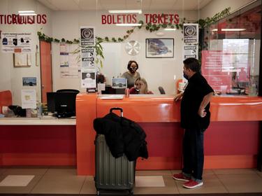 Pedro Luis Ruiz buys a bus ticket to go to Miami after crossing from Mexico into the U.S. to continue his asylum request, El Paso, Texas, March 11, 2021, photo by Jose Luis Gonzalez/Reuters