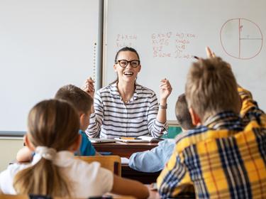 Female teacher lecture a new lesson to primary school kids in classroom., photo by BalanceFormCreative/AdobeStock