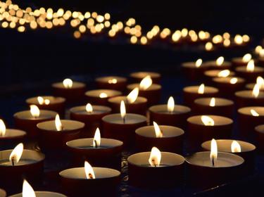 Burning memorial candles, photo by irisphoto1/AdobeStock