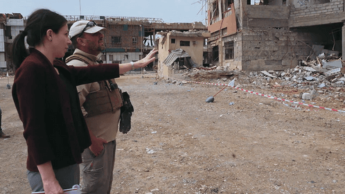 Shelly Culbertson and a United Nations Mine Action Service Implementation Partner survey the grounds of the Al-Shifa Hospital complex in Mosul, Iraq.